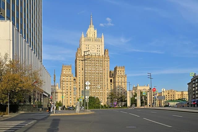 The Ministry of Foreign Affairs building with a spired tower stands against a blue sky.